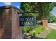 Royal Oaks community sign with brick pillars and lush landscaping provides an inviting entrance to the neighborhood at 5195 Overbend Trl, Suwanee, GA 30024