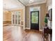 Elegant foyer with hardwood floors, decorative front door, and views into a formal dining area at 5195 Overbend Trl, Suwanee, GA 30024