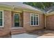 Elegant brick home featuring a decorative glass front door, sidelights, and a charming brick facade at 5195 Overbend Trl, Suwanee, GA 30024