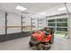 Spacious garage featuring ample storage shelves, a roll-up door, and a well-maintained lawn mower at 5195 Overbend Trl, Suwanee, GA 30024