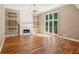 Bright living room with hardwood floors, a fireplace, and large windows providing lots of natural light at 5195 Overbend Trl, Suwanee, GA 30024
