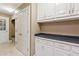 Welcoming mudroom with built-in storage cabinets, coat hooks, and a convenient bench seating area at 5195 Overbend Trl, Suwanee, GA 30024