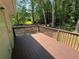 A wood deck off the back of the house overlooks a lush green tree line at 110 Stagecoach Trl, Stockbridge, GA 30281
