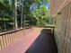 A wood deck off the back of the house overlooks a lush green tree line at 110 Stagecoach Trl, Stockbridge, GA 30281