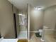 A walk-in shower with black trim in a neutral bathroom at 110 Stagecoach Trl, Stockbridge, GA 30281