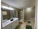 Bathroom with double sink vanity, walk-in shower and jacuzzi tub at 110 Stagecoach Trl, Stockbridge, GA 30281