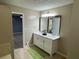 Bathroom featuring double vanity with white cabinet and modern black framed mirrors at 110 Stagecoach Trl, Stockbridge, GA 30281