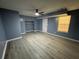 This bedroom features blue painted walls, recessed lighting, and modern laminate flooring throughout at 110 Stagecoach Trl, Stockbridge, GA 30281