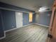 This bedroom features blue painted walls and modern laminate flooring throughout at 110 Stagecoach Trl, Stockbridge, GA 30281