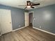 Bedroom boasts light gray wood-look floors and a modern ceiling fan at 110 Stagecoach Trl, Stockbridge, GA 30281