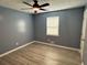 Bedroom boasts light gray wood-look floors and a modern ceiling fan at 110 Stagecoach Trl, Stockbridge, GA 30281