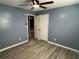 Bedroom boasts light gray wood-look floors and a modern ceiling fan at 110 Stagecoach Trl, Stockbridge, GA 30281