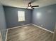Bedroom boasts light gray wood-look floors and a modern ceiling fan at 110 Stagecoach Trl, Stockbridge, GA 30281