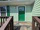 Inviting front entry with a tiled porch and bright green door at 110 Stagecoach Trl, Stockbridge, GA 30281