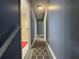 A hallway with grey walls and floors offers access to rooms at 110 Stagecoach Trl, Stockbridge, GA 30281
