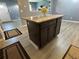 Features an island with stone countertop and dark-colored cabinets at 110 Stagecoach Trl, Stockbridge, GA 30281