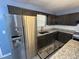Features a stainless steel refrigerator and dark-colored cabinets at 110 Stagecoach Trl, Stockbridge, GA 30281