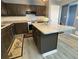 Presents an island with stone countertop and dark-colored cabinets at 110 Stagecoach Trl, Stockbridge, GA 30281
