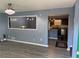 Bright living room with modern chandelier and view to the kitchen at 110 Stagecoach Trl, Stockbridge, GA 30281
