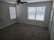 Well-lit bedroom with neutral walls, plush carpeting, and windows with blinds for privacy and comfort at 3120 Chattahoochee Rd, Cumming, GA 30041