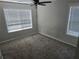 Bright bedroom featuring neutral walls, plush carpeting, and windows with blinds for natural light at 3120 Chattahoochee Rd, Cumming, GA 30041