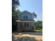 Charming two-story home featuring a covered porch, blue siding and well-maintained landscaping at 3120 Chattahoochee Rd, Cumming, GA 30041