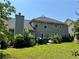 Spacious backyard with a well-maintained lawn, mature trees, and vinyl siding, offering a serene outdoor space at 3140 Ridge Hill Pkwy, Douglasville, GA 30135