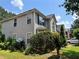 Side view of a two-story home featuring vinyl siding, well-maintained landscaping, and a neatly kept lawn at 3140 Ridge Hill Pkwy, Douglasville, GA 30135