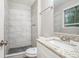 Bathroom featuring tiled walk-in shower, granite vanity and modern fixtures at 4442 Cedar Ridge Trl, Stone Mountain, GA 30083