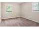 Bright bedroom with neutral carpet and two windows allowing for natural light at 4442 Cedar Ridge Trl, Stone Mountain, GA 30083