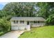Charming split-level home with a white brick facade, front porch, and attached two car garage at 4442 Cedar Ridge Trl, Stone Mountain, GA 30083