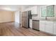 Kitchen featuring white cabinets, stainless steel dishwasher, and granite countertops at 4442 Cedar Ridge Trl, Stone Mountain, GA 30083