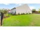 An expansive green backyard features mature landscaping with a view at 601 Cork St, Woodstock, GA 30188