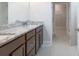 Bathroom featuring double sink vanity with granite countertop and walk-in closet at 601 Cork St, Woodstock, GA 30188