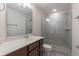 Modern bathroom with a glass-enclosed shower, marble countertop, and sleek fixtures at 601 Cork St, Woodstock, GA 30188