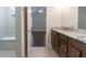 Bathroom featuring a double sink vanity with a granite countertop, leading to a bedroom at 601 Cork St, Woodstock, GA 30188