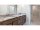 Bathroom featuring double sink vanity with granite countertop and walk-in closet at 601 Cork St, Woodstock, GA 30188