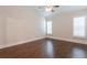 Bedroom featuring hardwood floors, bright windows and ceiling fan at 601 Cork St, Woodstock, GA 30188