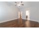 Bedroom boasts hardwood floors, a ceiling fan and access to a bathroom and staircase at 601 Cork St, Woodstock, GA 30188