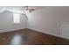 Spacious bonus room featuring hardwood floors, a window with shutters, and a ceiling fan at 601 Cork St, Woodstock, GA 30188