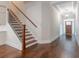 Welcoming foyer with hardwood floors, staircase, and elegant chandelier lighting, leading to the rest of the home at 601 Cork St, Woodstock, GA 30188