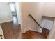 Hallway with hardwood floors, a staircase, and natural light, connecting various areas of the home at 601 Cork St, Woodstock, GA 30188
