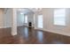 Open-concept living room featuring hardwood floors, a fireplace, and large windows with natural light at 601 Cork St, Woodstock, GA 30188