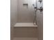 Close-up of neutral tiled shower with built-in bench at 601 Cork St, Woodstock, GA 30188