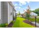 A home's side yard shows the manicured lawn and flowering trees at 601 Cork St, Woodstock, GA 30188