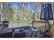 Cozy outdoor space featuring stylish patio furniture, a fire pit, and a wooded backyard view at 3915 Basil Sw Way, Atlanta, GA 30331