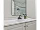 Bright bathroom featuring a white vanity and a shower with elegant tile and glass doors at 3915 Basil Sw Way, Atlanta, GA 30331