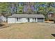 Charming single-story home featuring a neutral color, front lawn, and attached garage at 3915 Basil Sw Way, Atlanta, GA 30331