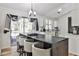 Bright eat-in kitchen with island, white cabinets, modern appliances, and sliding doors at 3915 Basil Sw Way, Atlanta, GA 30331