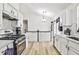 Open kitchen showcasing white cabinets, stainless steel appliances, and plenty of counter space at 3915 Basil Sw Way, Atlanta, GA 30331